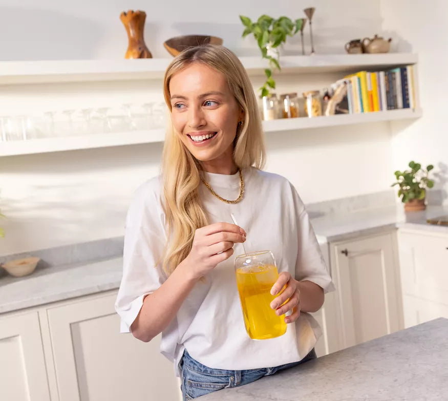 Woman drinking Herbalife Fibre Concentrate Sweet Orange Goji Berry